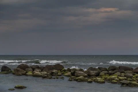 Rainy sunset on a seashore Stock Photos