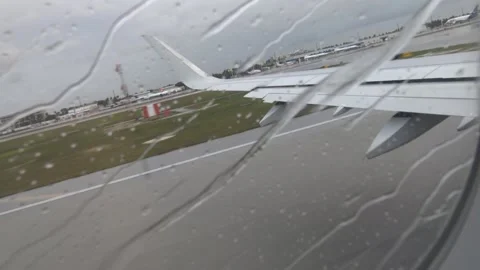 Rainy Takeoff Roll from Airplane Window at Miami Airport Stock Footage 321583049