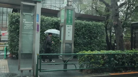 Rainy Tokyo Bus Stop Pedestrians Umbrellas Urban Street Scene View Stock Footage 335103295