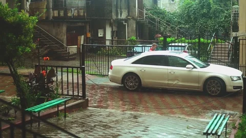 Rainy town lane with car Stock Footage 247195480