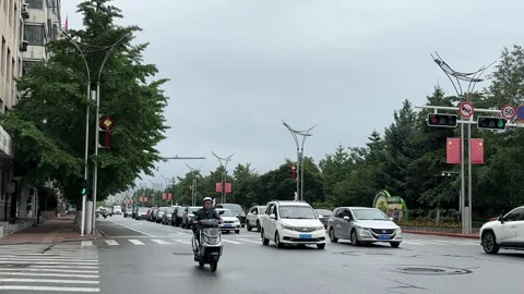 Rainy Traffic Moves Through a Central Street in Dandong China Stock Footage 340176069