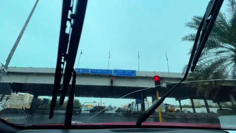 Rainy Traffic Under Kuwaiti Bridge – Windshield Wiper View in 4K. Stock-Footage 308733211