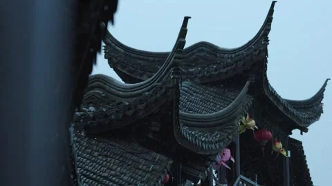 Rainy view of ancient Chinese upturned eaves with red lanterns in Suzhou Stock Footage 345655302