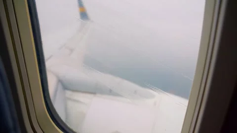 Rainy view through an airplane window with raindrops on the glass and a clo.. Stock Footage 294338965