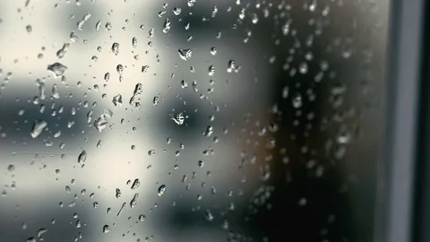 Rainy weather outside with drops falling on the window macro shot Video stock 73913084