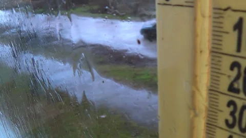 Rainy weather outside. Drops on the window glass, foggy thermometer scale Video stock 126824239