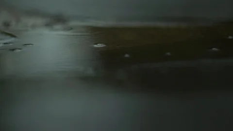 Rainy weather in a puddle drops falling Stock Footage 122275949