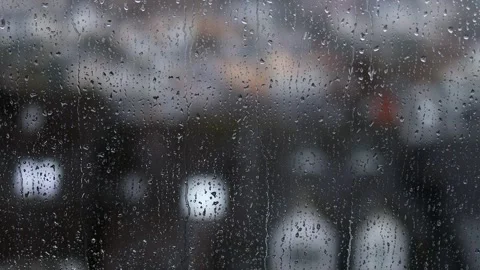 A rainy window in front of a city 4k 25fps video Stock Footage 259324890