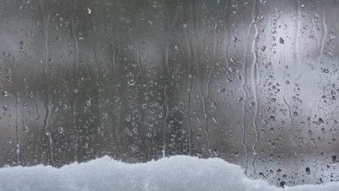 Rainy Window With Melting Snow And Water Droplets Falling Down Glass Stock Footage 326779509