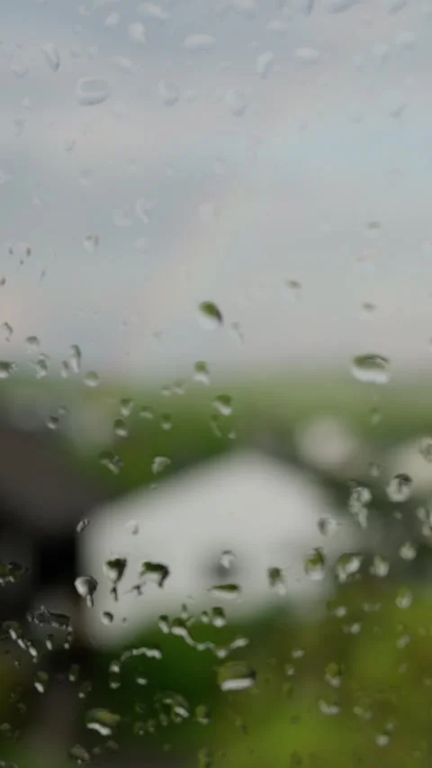 A Rainy Window View Featuring a Beautifully Blurred Landscape Outside the Glass Stock Footage 308742440
