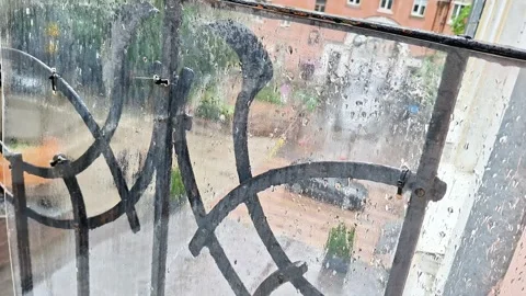 Rainy Window View with Wet Balcony Railing During Urban Stormy Day 스톡 동영상 337450275