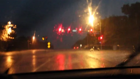Rainy windshield stoplight night Stock Footage 3880244