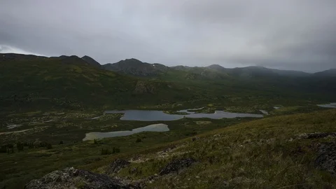 Rainy Yukon mountain range with lake 8K time lapse Stock Footage 111356140