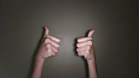 Raise both hands with a thumbs up gesture 写真素材