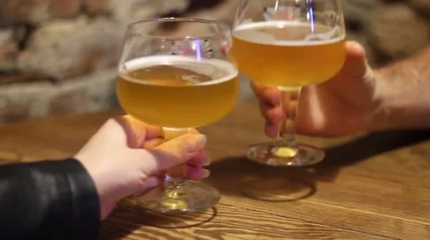 RAISE TWO GLASS OF PALE ALE BEER ON A TABLE IN BAR Video stock 65293312