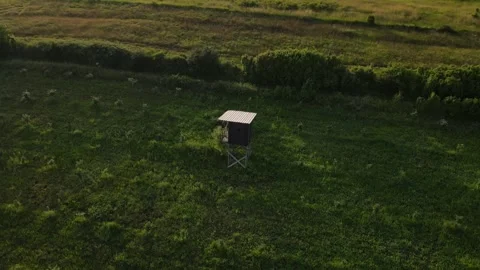 Raised hide high stand for animal hunt observation drone aerial view Stock Footage 244542209