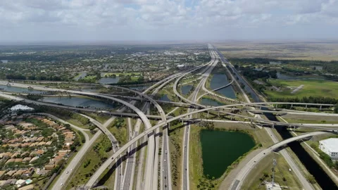 A raised highway interchange in Miami, bustling with moving vehicles, Stock Footage 306881589