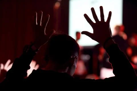Raised up a human hands at the event Stock Photos