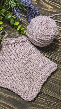A raised openwork pattern knitted with colored yarn on a wooden background. 스톡 사진
