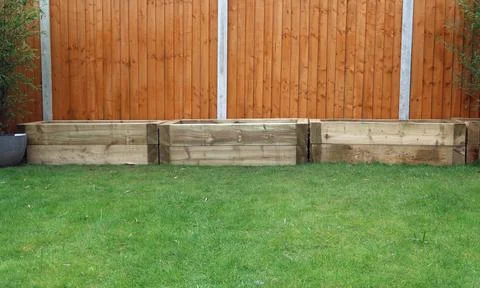 Raised vegetable, flower bed, made with Railway sleepers. Bamboo screening Stock Photos