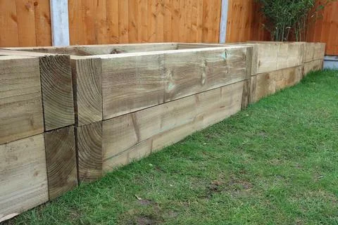Raised vegetable, flower bed, made with Railway sleepers. Bamboo screening Stock Photos