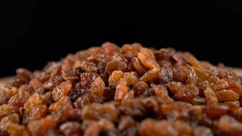 Raisin rotates on a black background Stock Footage