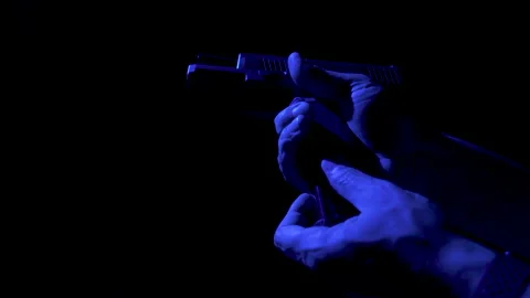 Raising Gun Loading Backlit Blue Light 스톡 동영상 157450994