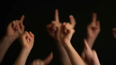 Raising hands on black background. Stock Footage 106808228