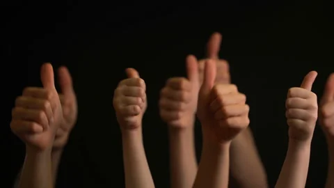 Raising hands with thumbs up on black background. Stock Footage 106737364