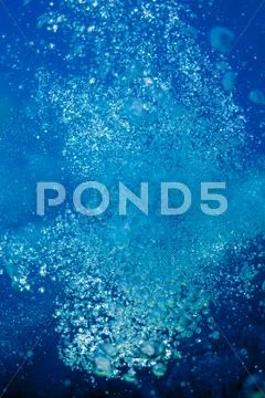 Raising underwater bubbles in the blue sea Stock Photos