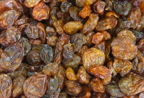 Raisins as abstract background texture, dark and colored, closeup top view Stock Photos