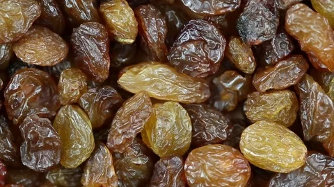 Raisins close up. Loop rotation. Front of the camera rotates plate with raisins Stock Footage 70962231