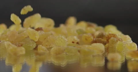 Raisins fall from side on a mirror surface Stock Footage 197427307