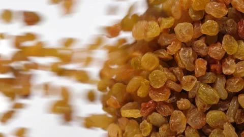 Raisins fall in slow motion and cover the whole screen, vertical video Stock Footage 172215337