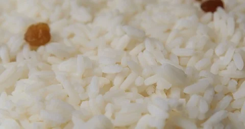 Raisins falling into rice Stock Footage 95559610