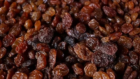 Raisins. Raisin grains rotating pattern macro texture background backdrop Stock Footage 91378130