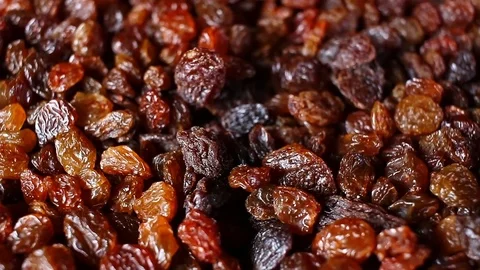 Raisins. Raisin grains rotating pattern macro texture background backdrop Stock Footage 91378187