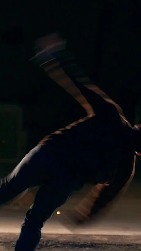 Raize, tricks of martial arts, night city against the background sparks, slow Stock Footage 346755246
