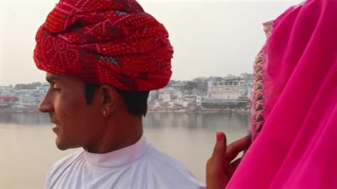 Rajasthani couple watching the sun setting at the Pushkar Lake  Stock Footage 70203742