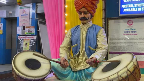 Rajasthani Puppet figure playing drum at a railway station Stock Footage 157734111
