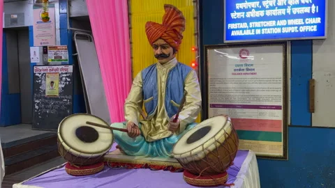 Rajasthani Puppet figure playing drum at a railway station Stock Footage 157734144