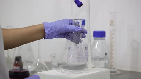 Rajkot, India - 06/10/2024: Testing different drugs in a beaker inside the Stock Footage 277870467