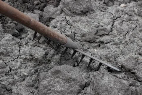 Rake breaking clods Stock Photos