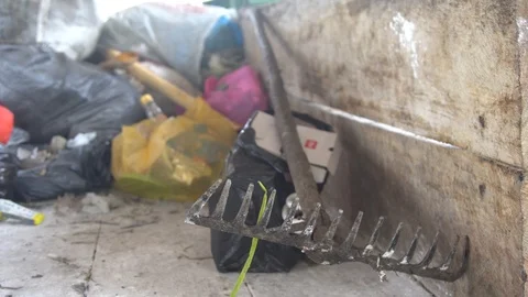 A rake for cleaning garbage lie. Asian dump. sorting of garbage. Video stock 127368843