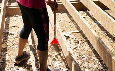 Raking between wood studs while installing a new deck Stock Photos