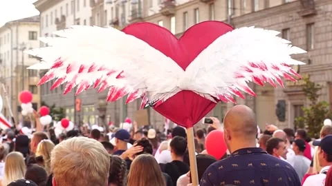 Rally against violence in Belarus. People carry a big heart with the wings of an Stock Footage