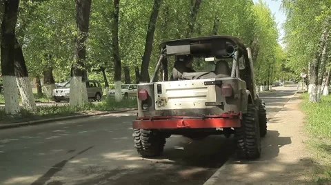 Rally SUV on big wheels, the driver get into the car and the car drives off. Stock Footage 58092206