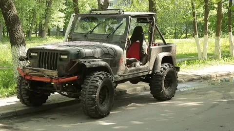 Rally SUV on big wheels parked beside the road. The driver get into the car. Stock Footage 58087258
