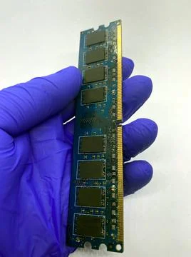 RAM memory kept in a gloved hand closeup view isolated on white background Stock Photos