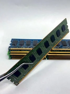 RAM memory on pincer closeup view with a stack of RAM isolated on white in ba Foto stock